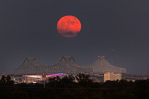 A super blue moon rises above the Mississippi River and Crescent City Connection Bridge in New Orleans, on August 30, 2023